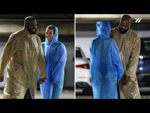Bianca Censori struggles to protect her modesty as she goes NUDE under a clear raincoat for a studio