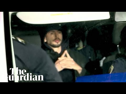 Andrew Tate escorted by Romanian police officers after raid