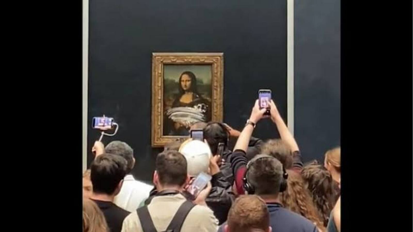 The glass panel protecting Mona Lisa had cake spread all over it